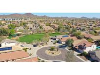 Expansive aerial view showcases the neighborhood with green spaces and mountain views at 2411 W Oberlin Way, Phoenix, AZ 85085