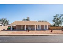 Charming single-story home with a desert landscape and a covered parking area in a suburban neighborhood at 3243 E Forge Ave, Mesa, AZ 85204
