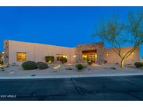 Desert home features a front yard with xeriscaping and a stone accent entry at 37015 N 27Th Pl, Cave Creek, AZ 85331
