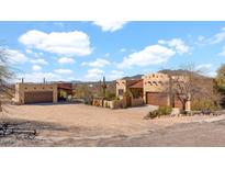 Desert home featuring a sand lot, garage, neutral stucco, and a terracotta-colored roof at 40108 N 2Nd Way, Phoenix, AZ 85086