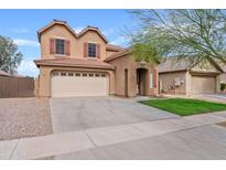 Charming two-story home showcasing a well-manicured front lawn and welcoming curb appeal at 4098 E Rustler Way, Gilbert, AZ 85297