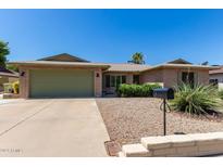 Charming single-story brick home featuring desert landscaping and a spacious two-car garage at 4855 W Turquoise Ave, Glendale, AZ 85302