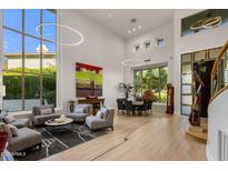 Open concept living room with soaring ceilings and large windows offering abundant natural light at 6522 N 27Th St, Phoenix, AZ 85016