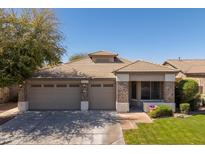 Charming single story home featuring a three-car garage, low maintenance landscaping, and a tile roof at 7214 N 88Th Ln, Glendale, AZ 85305