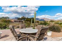 Outdoor patio featuring a dining table with mountain views, perfect for entertaining or enjoying the desert scenery at 7380 E Canyon Wren Dr, Gold Canyon, AZ 85118