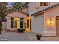 Inviting home exterior featuring a charming facade, desert landscaping, and warm lighting at 741 N Cholla St, Chandler, AZ 85224