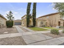 Charming home featuring a tile roof, desert landscaping, and a spacious driveway leading to a two-car garage at 863 E Waterview Pl, Chandler, AZ 85249