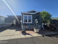 Charming single-story home with well-manicured landscaping and cozy outdoor seating area at 8700 E University Dr # 649, Mesa, AZ 85207