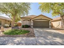 Charming single-Gathering home with a well-maintained front yard and a two-car garage at 9331 W Harmony Ln, Peoria, AZ 85382