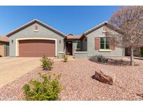 Charming exterior with a two-car garage, desert landscaping and rock mulch at 10822 E Ramblewood Cir, Mesa, AZ 85212
