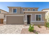 Charming two-story home featuring a two-car garage, manicured landscaping, and a welcoming entrance at 11619 W Green Dr, Youngtown, AZ 85363