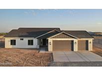 Charming single-story home featuring a three-car garage and a modern, neutral color scheme in a desert environment at 20179 W Highland Ave, Litchfield Park, AZ 85340