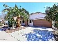 Charming single-story home featuring a well-manicured lawn and a two-car garage at 21047 N Alma Dr, Maricopa, AZ 85138