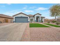 Beautiful single-story home featuring a two-car garage, landscaped front yard, and charming curb appeal at 35282 N Shorthorn Trl, San Tan Valley, AZ 85143