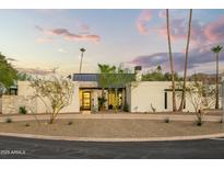 Beautiful modern home with manicured desert landscaping and a circular driveway at 4625 E Mountain View Rd, Phoenix, AZ 85028