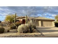 Charming single-story home with a desert landscaped front yard and attached two-car garage at 9142 E La Posada Ct, Scottsdale, AZ 85255