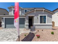 Charming two-story home featuring a gray exterior, two-car garage and manicured front yard at 11627 W Green Dr, Youngtown, AZ 85363
