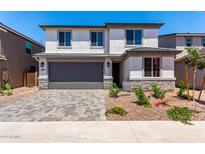 Two-story home features a grey garage door, neutral paint, and desert landscaping for optimal curb appeal at 11635 W Beck Ave, Youngtown, AZ 85363