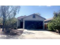 Charming single-story home featuring a two-car garage, desert landscaping, and a welcoming entrance at 13001 W Aster Dr, El Mirage, AZ 85335