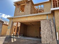 View of a home under construction showing the framing, sheathing, and garage door, sunny sky at 21232 N 58Th St, Phoenix, AZ 85054