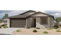 Charming single-story home featuring a gray-tone facade, well-maintained landscaping, and a convenient two-car garage at 5629 W Mcneil St, Laveen, AZ 85339