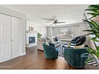 Comfortable living room with a fireplace, plush seating, and ample natural light from a window at 8213 E Whitton Ave, Scottsdale, AZ 85251