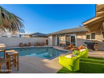 Inviting backyard pool area with lounge chairs and well-maintained landscaping creating an ideal outdoor relaxation spot at 8213 E Whitton Ave, Scottsdale, AZ 85251