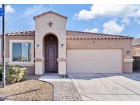 Charming single-story home with desert landscaping, arched entryway, and a two car garage at 1051 W Inca St, Mesa, AZ 85201