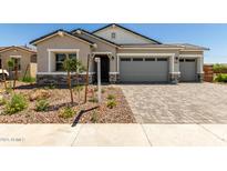 Charming single-story home with desert landscaping and a two-car garage on a sunny day at 12029 W Marguerite Ave, Avondale, AZ 85323