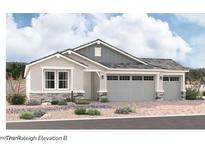 Charming single-story home with a two-car garage, stone accents, and a well-manicured front yard at 12029 W Marguerite Ave, Avondale, AZ 85323