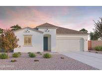 Charming single-story home with white stucco, tile roof, and a well-manicured desert landscape at 12633 W Luxton Ln, Avondale, AZ 85323