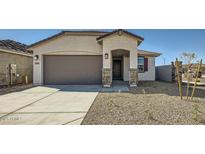 Inviting single-Gathering home boasting a two-car garage and desert landscaping at 15065 W Hackamore Dr, Surprise, AZ 85387