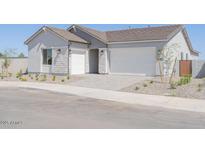 Charming single-story home with a three-car garage and well-maintained front yard at 1892 E Empeltre Rd, San Tan Valley, AZ 85140