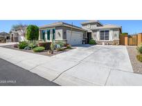 Charming single-story home with desert landscaping and a spacious concrete driveway at 19672 N 260Th Ave, Buckeye, AZ 85396