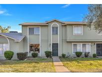Inviting townhome with a well-maintained lawn, bushes, and charming facade at 2604 W Wolf St, Phoenix, AZ 85017