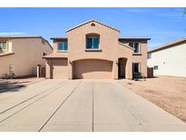 Inviting two-story home with a spacious driveway and attached two-car garage at 28050 N Limestone Ln, San Tan Valley, AZ 85143
