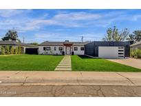 Beautifully renovated single story home with green grass, walkway and modern exterior at 4809 N 30Th Pl, Phoenix, AZ 85016