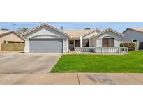 Charming single-story home with a well-maintained lawn and neutral-colored exterior at 5258 E Elena Ave, Mesa, AZ 85206