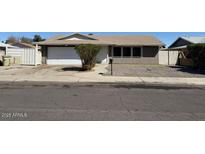 Single-story home with a large front yard, gravel landscaping, and a two-car garage at 5639 N 46Th Ave, Glendale, AZ 85301