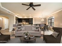 Staged living room with modern furniture, open to kitchen and dining area, and plenty of natural light at 7601 E Indian Bend Rd # 2056, Scottsdale, AZ 85250