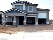 Attractive two-story home with a gray exterior, brick accents, and an attached two-car garage at 10039 W Verde Ln, Avondale, AZ 85392