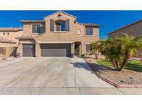 Charming two-story home with a three-car garage and beautiful desert landscaping in front at 11872 W Sherman St, Avondale, AZ 85323