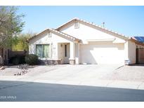 Charming single-story home with well-maintained landscaping, private drive, and a two-car garage at 16120 W Kendall St, Goodyear, AZ 85338