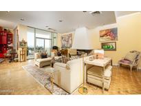 Bright living room features a fireplace, large windows, and comfortable seating at 2323 N Central Ave # Ph-C, Phoenix, AZ 85004