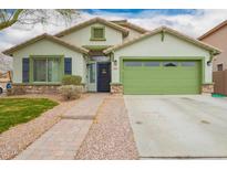 Charming single-Gathering home with a two-car garage, manicured lawn, and inviting curb appeal at 25844 W Watkins St, Buckeye, AZ 85326