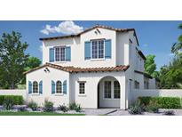 Charming two-story home with white stucco, red tile roof, blue shutters and beautifully landscaped front yard at 26421 N 22Nd Dr, Phoenix, AZ 85085