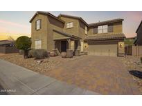 Stunning two-story home with a neutral color scheme, desert landscaping, and a charming paver driveway at 2926 W Thorn Tree Dr, Phoenix, AZ 85085