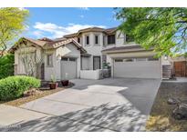 Beautiful two-story home with a three-car garage and a well-manicured front yard at 29374 N 125Th Dr, Peoria, AZ 85383