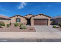 Charming single-story home featuring desert landscaping, stone accents, and a two-car garage at 37051 N Rhinelander Dr, San Tan Valley, AZ 85140