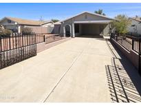 Charming single-story home featuring a spacious driveway and beautifully decorative iron fencing at 4119 N 78Th Ave, Phoenix, AZ 85033